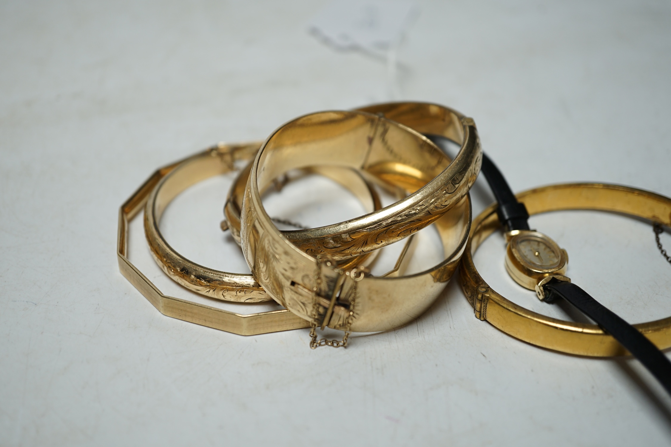 A lady's modern 14k Omega manual wind wrist watch and five assorted metal bangles. Condition - poor to fair